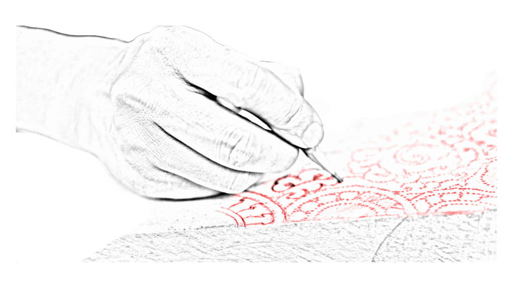 A sketch of a hand drawing a bright red ornamental pattern