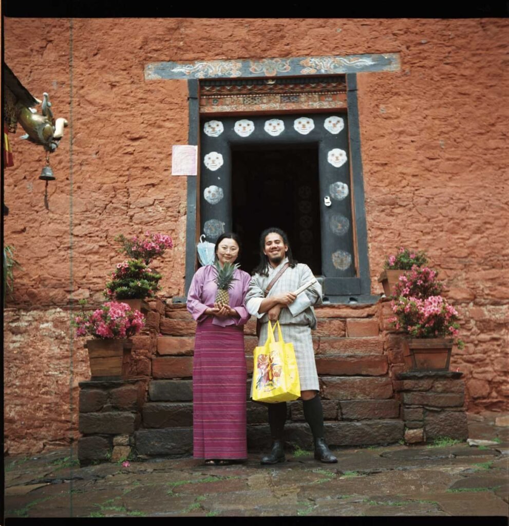 2025June19_Thimphu_Y_KP800_Dechenphug_DfT_offering-scaled Two young Bhutanese pause for a photo with offerings before they enter a temple